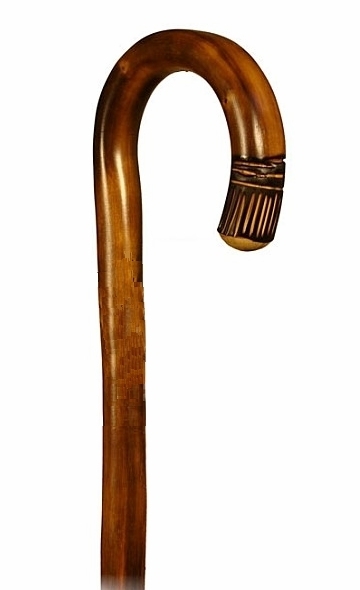 Bastón, de 1 sola pieza, curvo en madera de castaño flameado con talla. Contera goma.